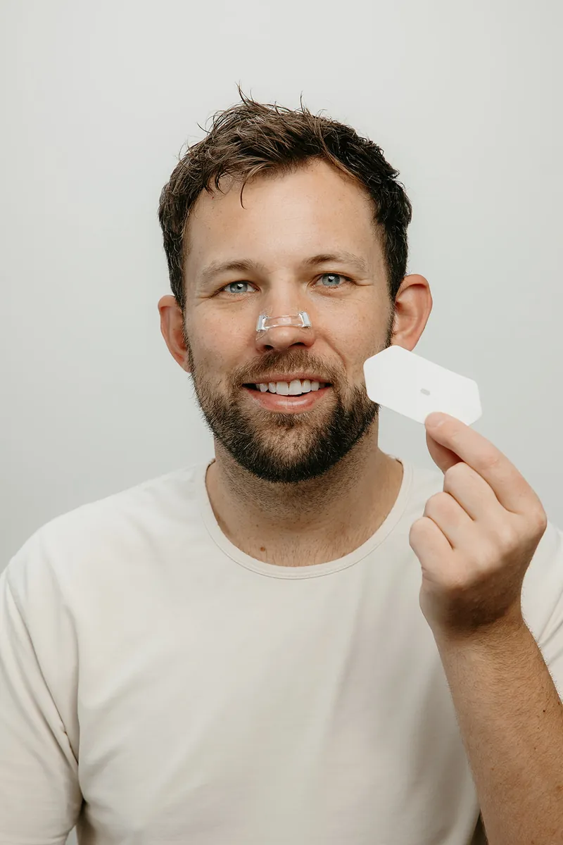 Man wearing the Intake magnetic nasal dilator on his nose